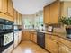 Well-lit kitchen featuring wooden cabinets, granite countertops, and modern appliances at 106 Boyter Ct, Cramerton, NC 28032