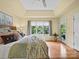 Comfortable main bedroom featuring a tray ceiling, a large window and door to a deck at 106 Boyter Ct, Cramerton, NC 28032