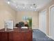 Well-lit home office featuring custom track lighting, a desk, comfortable chair, and ample storage space at 106 Boyter Ct, Cramerton, NC 28032