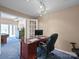 Bright home office with wood desk, granite top, and plush blue carpet at 106 Boyter Ct, Cramerton, NC 28032