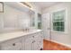 Updated bathroom with white vanity, hardwood floors, and modern fixtures at 10606 Danesway Ln, Cornelius, NC 28031