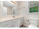 Bright bathroom with single vanity, laminate flooring, and natural light at 10606 Danesway Ln, Cornelius, NC 28031