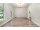 Bright dining room with new hardwood floors, chandelier, and natural light at 10606 Danesway Ln, Cornelius, NC 28031