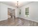 Spacious dining room with hardwood floors, large windows, and chandelier at 10606 Danesway Ln, Cornelius, NC 28031