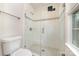 Bathroom features a glass shower with white tile and mosaic accents at 10606 Danesway Ln, Cornelius, NC 28031