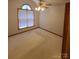 Bright, empty bedroom featuring a window, neutral carpet, and base trim at 110 Kimberly Ln, Kings Mountain, NC 28086
