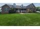 Inviting brick home with a covered front porch and green lawn, showcasing classic curb appeal at 110 Kimberly Ln, Kings Mountain, NC 28086
