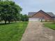 Side view of home featuring a two car garage and long driveway in a serene surrounding at 110 Kimberly Ln, Kings Mountain, NC 28086