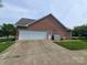 Side view of the brick home featuring a spacious garage with an ample concrete driveway at 110 Kimberly Ln, Kings Mountain, NC 28086