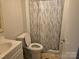 Bathroom with decorative shower curtain, toilet, and vanity with sink at 1150 Wyatt Grove Church Rd, Gold Hill, NC 28071