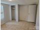 View of bedroom with tiled floors, closet, and door to the backyard at 1150 Wyatt Grove Church Rd, Gold Hill, NC 28071