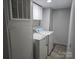 Laundry room featuring a washer, dryer, cabinets, and vinyl flooring at 1150 Wyatt Grove Church Rd, Gold Hill, NC 28071