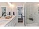 Stylish bathroom featuring double sinks, marble countertops, and a glass-enclosed shower with tile surround at 122 Wesser St # 14, Davidson, NC 28036
