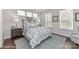 Relaxing bedroom featuring three large windows, soft blue and white tones, a comfortable bed, and modern furnishings at 122 Wesser St # 14, Davidson, NC 28036