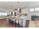 Spacious kitchen features an island with barstool seating, pendant lighting, and modern appliances with hardwood floors at 122 Wesser St # 14, Davidson, NC 28036
