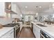 Elegant kitchen featuring stainless steel appliances, subway tile backsplash, white cabinetry, and a view into the dining area at 122 Wesser St # 14, Davidson, NC 28036