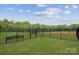 Enclosed dog park with bench, grassy area, and a secure fence for residents and their pets at 1227 Hallman Branch Ln, Lincolnton, NC 28092