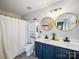 Modern bathroom featuring a double sink vanity, gold accents, and stylish mirrors at 12320 Verdant Ct, Charlotte, NC 28273