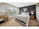 Modern bedroom with a striking accent wall, plush bedding, and natural light from the large window at 12320 Verdant Ct, Charlotte, NC 28273