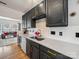 Modern kitchen featuring stainless steel appliances, dark cabinets with gold hardware, and quartz countertops at 12320 Verdant Ct, Charlotte, NC 28273
