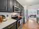 Well-equipped kitchen with stainless steel appliances, dark cabinets, and modern countertops at 12320 Verdant Ct, Charlotte, NC 28273