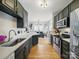Modern kitchen featuring stainless steel appliances, dark cabinets, and hardwood flooring at 12320 Verdant Ct, Charlotte, NC 28273
