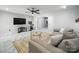 Open concept living area featuring a comfortable couch, entertainment center, and access to other areas of the home at 12320 Verdant Ct, Charlotte, NC 28273