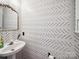 Chic powder room with patterned wallpaper and vintage-style mirror at 12320 Verdant Ct, Charlotte, NC 28273
