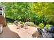 A spacious backyard patio with an outdoor seating area, with a lush green lawn at 1241 Brough Hall Dr, Waxhaw, NC 28173