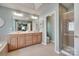 A full bathroom featuring a double sink vanity, a glass enclosed shower, and a separate toilet area at 1241 Brough Hall Dr, Waxhaw, NC 28173