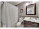 Bathroom featuring a shower with white curtain, modern vanity, and decorative tile accents at 1241 Brough Hall Dr, Waxhaw, NC 28173