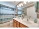 Bathroom featuring a double sink vanity, patterned shower curtain, and ample lighting at 1241 Brough Hall Dr, Waxhaw, NC 28173