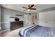 Bedroom with ceiling fan, large dresser, and shelves. Perfect for rest and relaxation at 1241 Brough Hall Dr, Waxhaw, NC 28173