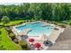Overhead view of a community pool with ample seating, umbrellas, and well-maintained landscaping at 1241 Brough Hall Dr, Waxhaw, NC 28173