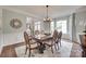 Dining room with a wooden table, upholstered chairs, and ample natural light, creating an inviting space at 1241 Brough Hall Dr, Waxhaw, NC 28173