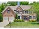 Charming brick home with a well-manicured lawn and a two-car garage, blending elegance with functionality at 1241 Brough Hall Dr, Waxhaw, NC 28173