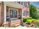 Inviting front porch features decorative double doors, potted plants, and charming accents for a warm welcome at 1241 Brough Hall Dr, Waxhaw, NC 28173