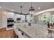 Spacious kitchen with granite countertops, white cabinets, stainless appliances, and island with seating at 1241 Brough Hall Dr, Waxhaw, NC 28173