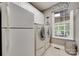 Bright laundry room featuring modern appliances, a window, and ample storage space at 1241 Brough Hall Dr, Waxhaw, NC 28173