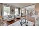 Inviting living room with hardwood floors, stylish seating, and a view of the entry, creating a welcoming atmosphere at 1241 Brough Hall Dr, Waxhaw, NC 28173