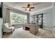 Bright office space with large windows, a wooden desk, and a bookshelf, creating an ideal workspace at 1241 Brough Hall Dr, Waxhaw, NC 28173