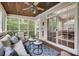 Relaxing screened porch with comfortable seating, ceiling fan, and a view of the backyard at 1241 Brough Hall Dr, Waxhaw, NC 28173