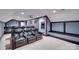 Cozy theater room with plush seating, projector, and a wet bar for ultimate entertainment experience at 1241 Brough Hall Dr, Waxhaw, NC 28173