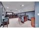 A theater room featuring a wet bar with seating, a projector, and tiered seating at 1241 Brough Hall Dr, Waxhaw, NC 28173