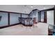 A wet bar with seating and decor, inside a home theater room with tiered seating and projector at 1241 Brough Hall Dr, Waxhaw, NC 28173
