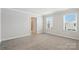 Carpeted bedroom with natural light, neutral walls, and a doorway to an ensuite bathroom at 125 Cedar Knoll Cir, Pineville, NC 28134
