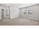 Neutral bedroom with carpet flooring, natural light, and an open doorway at 125 Cedar Knoll Cir, Pineville, NC 28134