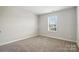 Inviting bedroom with soft carpeting and ample natural light from the window at 125 Cedar Knoll Cir, Pineville, NC 28134