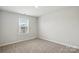 Well-lit bedroom featuring soft carpeting and a view from the bright window at 125 Cedar Knoll Cir, Pineville, NC 28134
