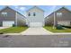 Exterior view of a modern home featuring a neat two-car garage and lawn at 125 Cedar Knoll Cir, Pineville, NC 28134